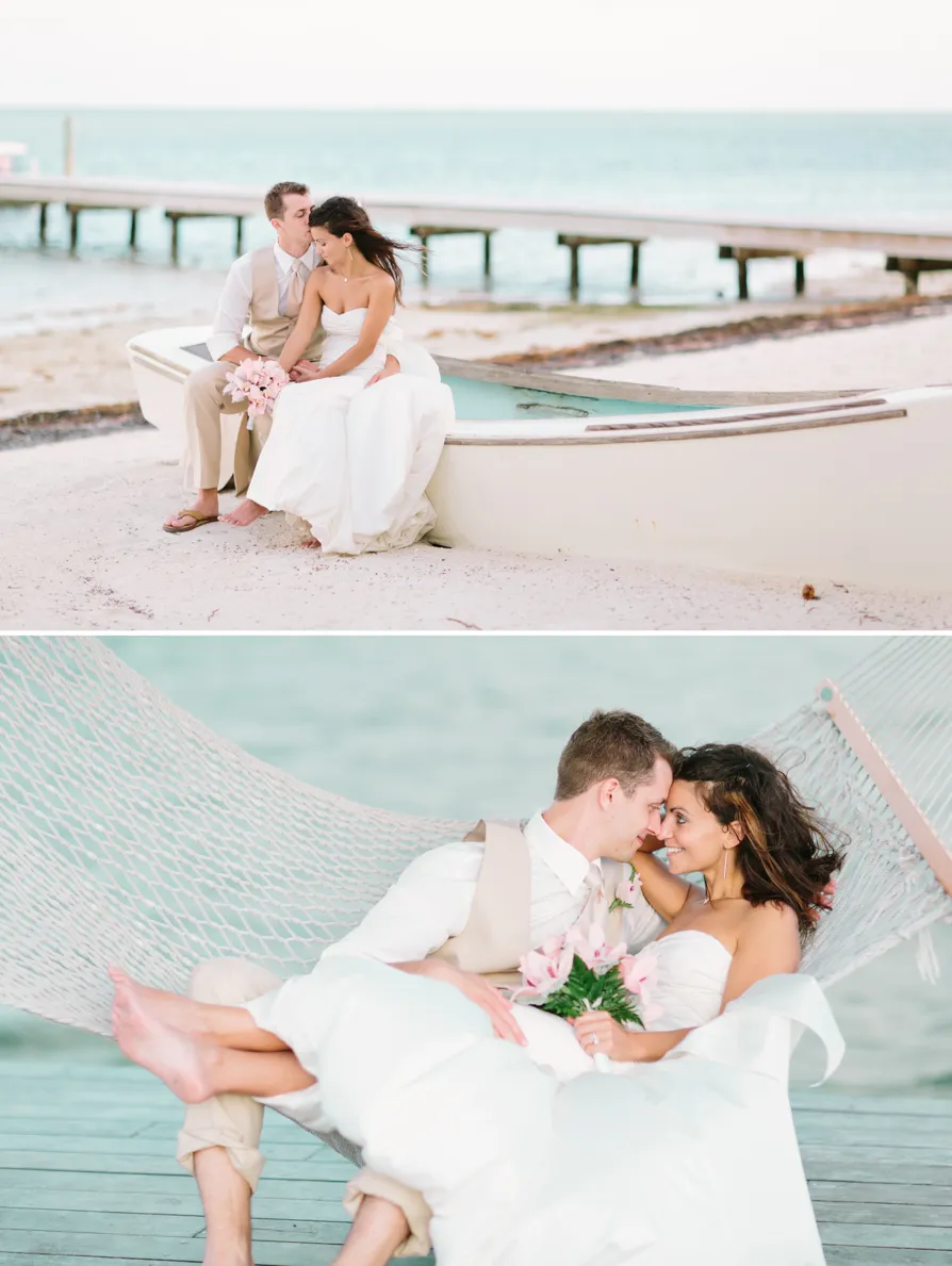 A serene beach with clear skies and a palm tree leaning over the shore.
