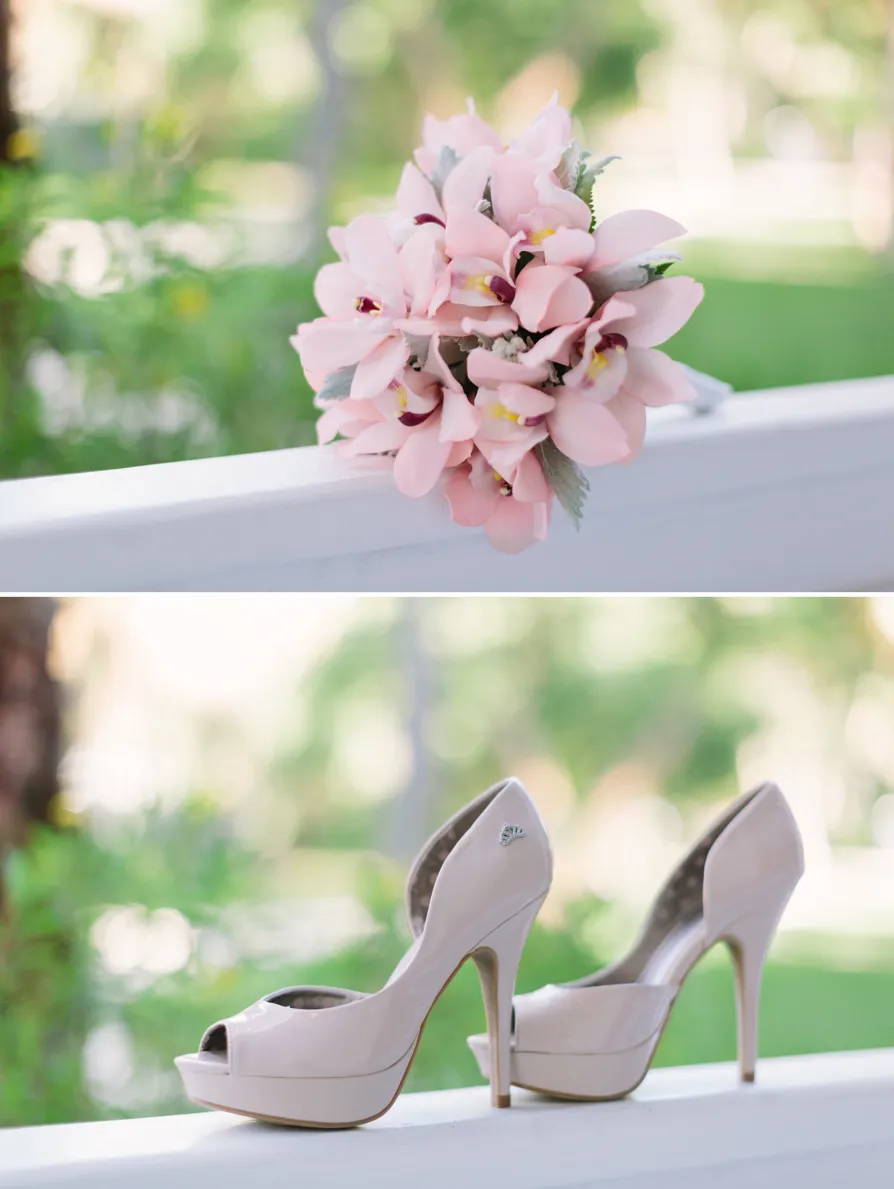 Elegant bridal bouquet and high-heeled shoes on a white railing.