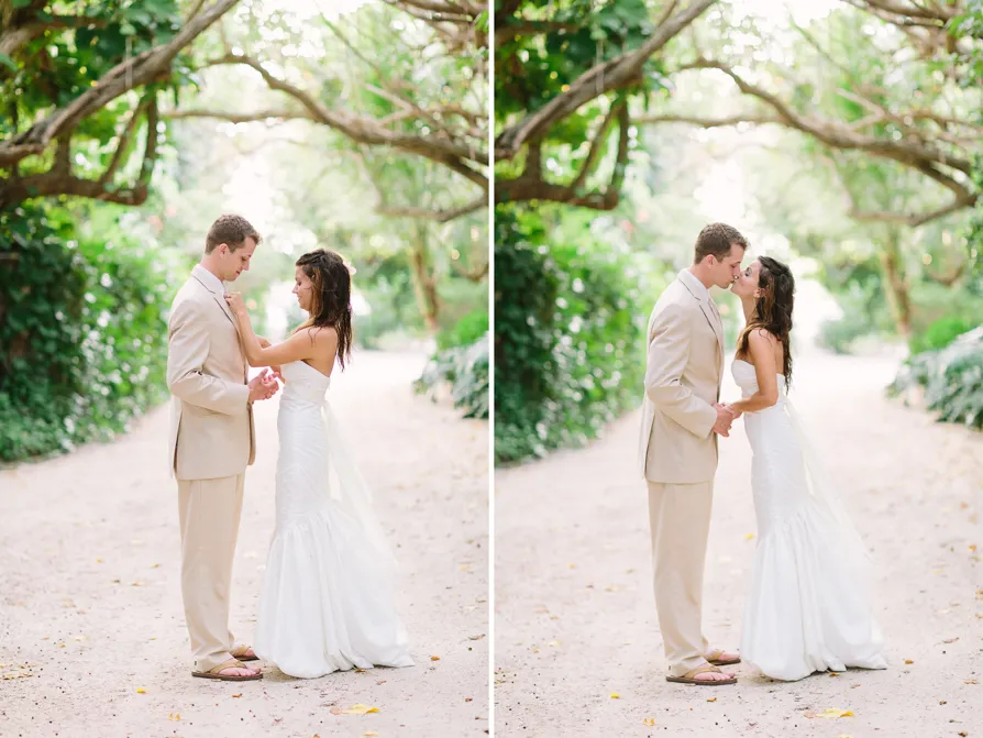 Bride and groom share a tender moment in a sunlit forest.
