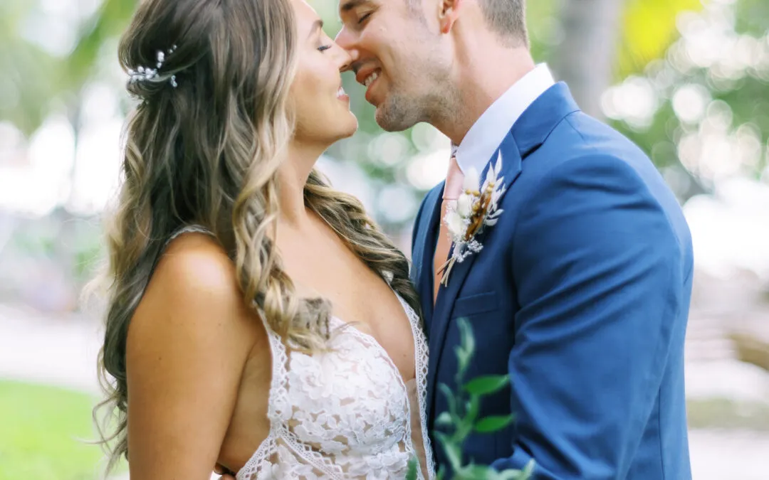 A couple sharing a romantic moment outdoors on their wedding day.